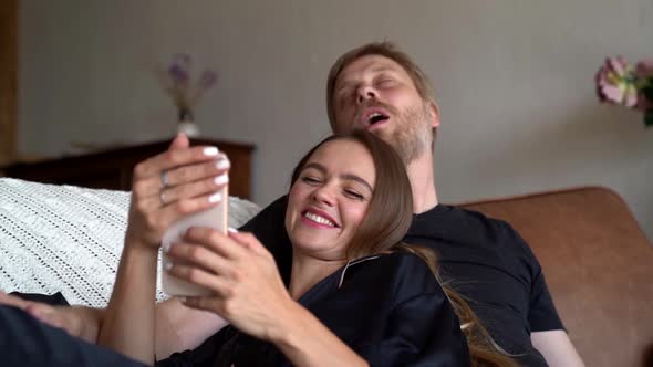 Loving Couple Is Taking Selfies By Smartphone at Home for Memory, Man and Woman Are Joking