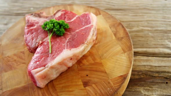 Raw steak garnished with herb