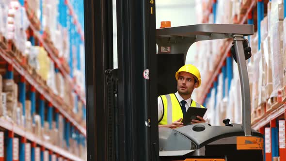 Male warehouse worker using digital tablet