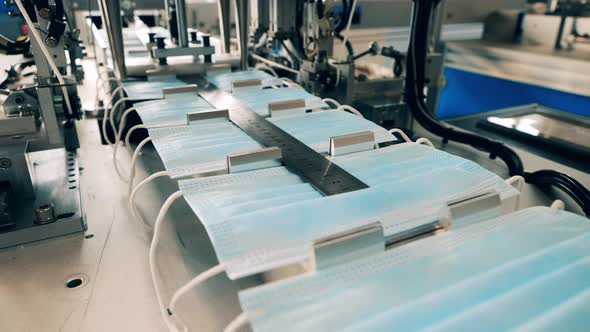 Medical Protective Masks Production. Face Masks Are Being Transported By the Conveyor