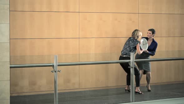 Businesswomen fighting over clock