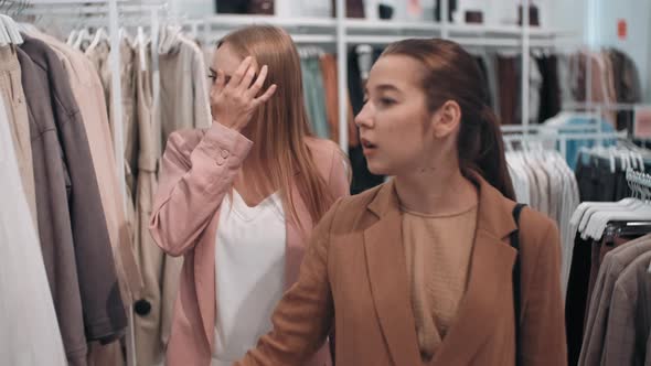 Young Women Choosing Clothes in Store