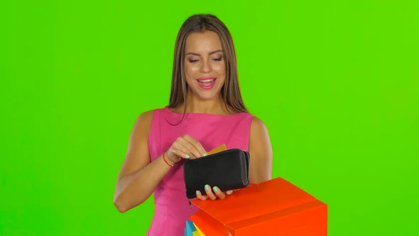Girl with Credit Card and Shopping Bags. Green Screen