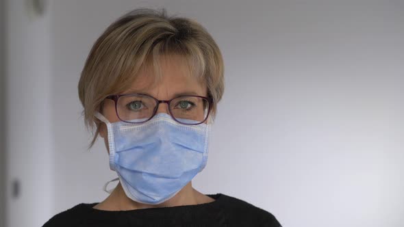 Covid 19 - attractive woman taking off her surgical mask and smiling