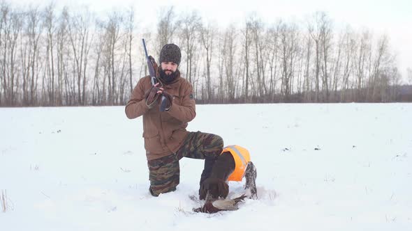 Happy Hunter with Dog and Their Game