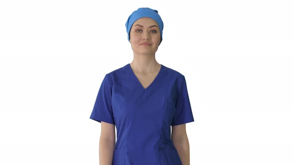 Confident Nurse or Doctor in Blue Uniform Walking Towards the Camera on White Background.