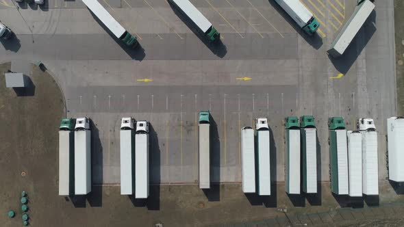 Buildings of Logistics Center Warehouses Near the Highway View From Height a Large Number of Trucks