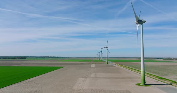 Wind turbines generating electricity in a flat Dutch landscape.