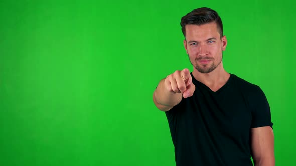 Young Handsome Caucasian Man Points To Camera with Finger - Green Screen