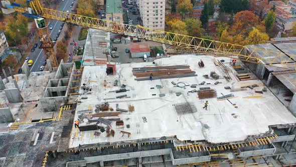 Aerial view of a new construction site. Top view on a roof of high-rise building in autumn 