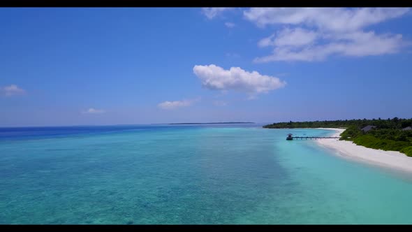 Aerial drone shot landscape of perfect lagoon beach holiday by blue green sea with white sandy backg