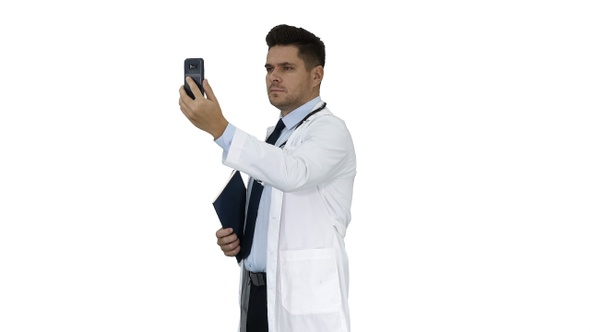 Male doctor making a video call talking to his patient