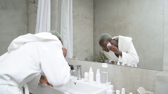 Goodlooking Man in Bathrobe Looking at Mirror in the Morning