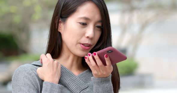 Woman use of mobile phone at outdoor park
