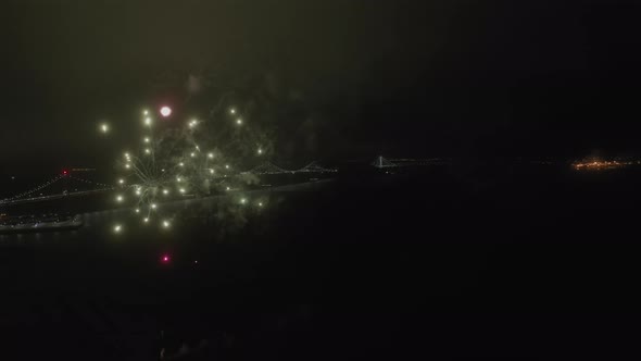 Colorful Fireworks Against the Background of Night City View and Illuminated bridge