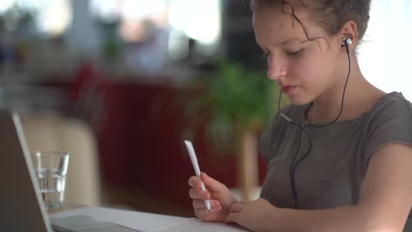 Portrait of a Cute Teenage Girl Having a Video Online Lesson