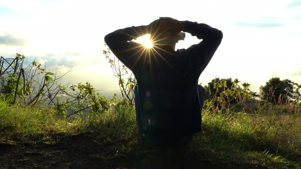 Man Hermit Meeting Up Sun Rise on the Edge of Mountains