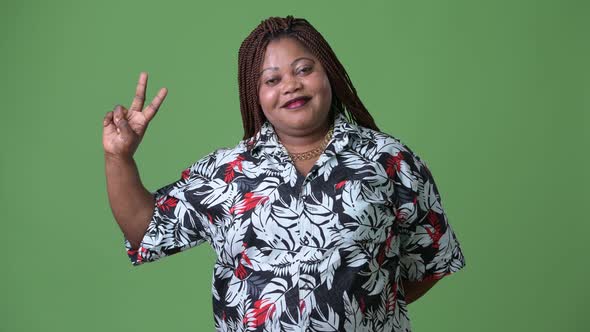 Overweight Beautiful African Woman Against Green Background