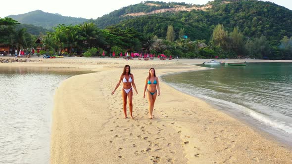 Women posing on relaxing coast beach time by blue sea with white sandy background of Koh Phangan nea