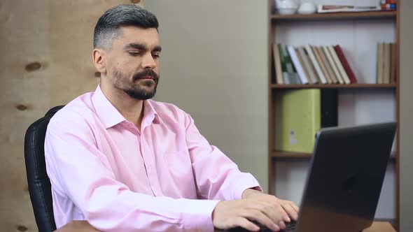 Middle-Aged Businessman Typing New Ideas to Create His Own Start-Up Company