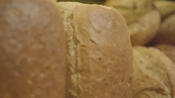 Camera Moving Along Shelf with Fresh Baked Bread. Close-up of Delicious Bakery Lying in Grocery for