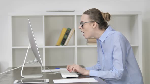 Young Casual Girl in Shock While Working on Computer