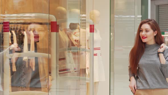 Beautiful Happy Woman Smiling To the Camera, Holding Her Shopping Bags