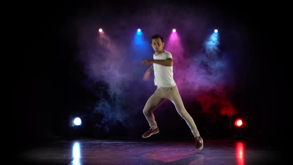 Trendy Young Man Dancing Single in Club, Neon Light, Lots of Smoke. Fashion Street Wear.