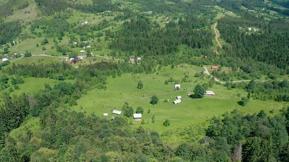 Aerial Drone View of Houses in a Mountain Valley on a Summer Day