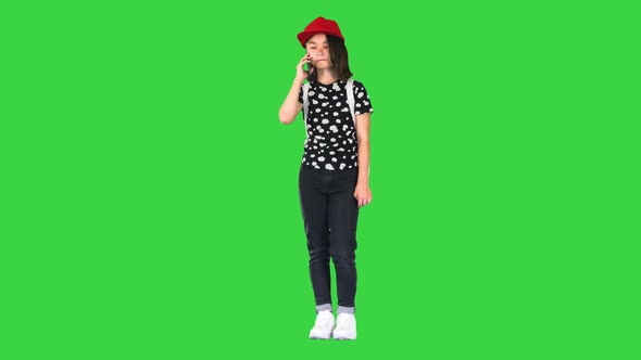 Young Asian Girl Talking on Smart Phone on a Green Screen Chroma Key