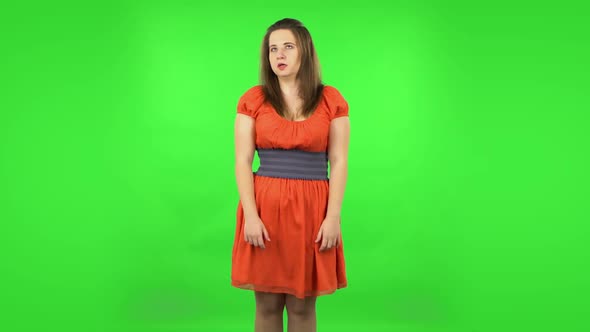 Cute Girl Is Upset, Waving Her Hands in Indignation, Shrugs. Green Screen