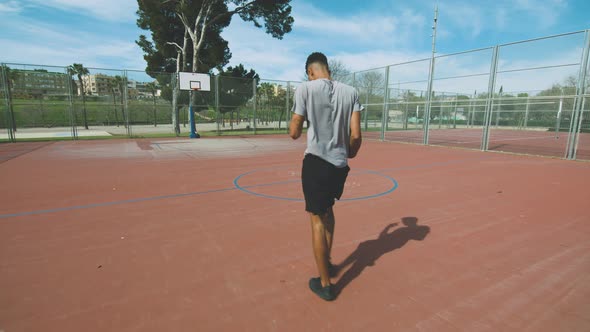 Black athlete dribbling and shooting basketball ball