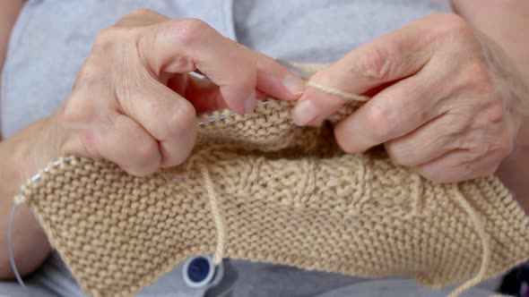 Closeup of Knitting a Grandmother Knits Warm Woolen Socks for Her Grandchildren for Winter