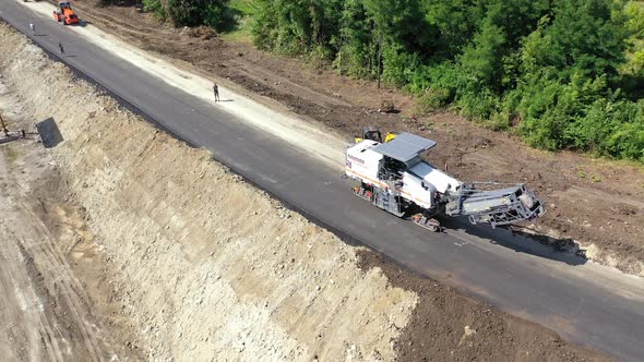 Aerial shot of road construction. Aerial view of asphalting machines during highway construction