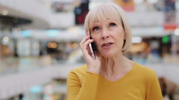 Mature Woman Talking on Cellphone Caucasian Serious Female Teacher Discussing Using Smartphone