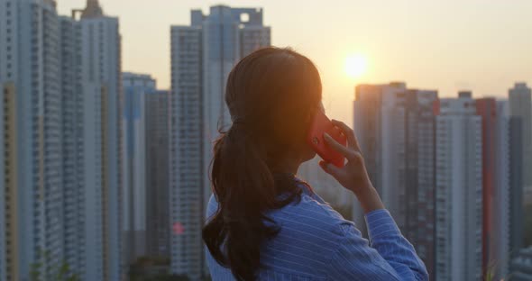 Woman look at the building in city and thinking under sunset