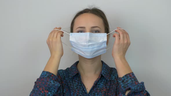 Woman takes off protective medical mask and hard breathing, in panic of epidemic virus danger