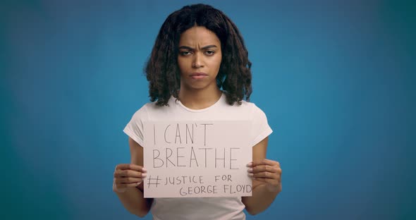 Black Girl Holding Placard with Text I Can't Breathe