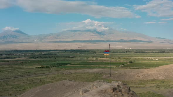 Aerial Drone Shot Zoom Out Shot of Flag Waving on the Hill in Armenia