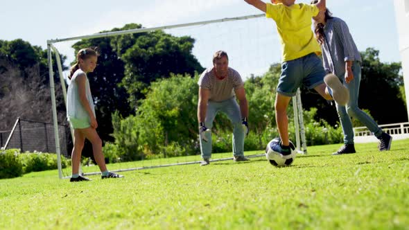 Happy family playing football