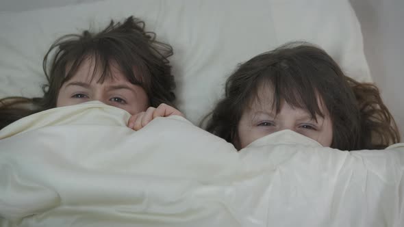 Frightened children under the covers.