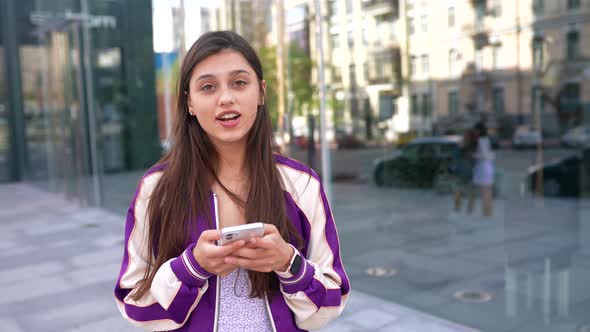 Playful Portrait of Pretty Young Woman Having Fun at the Street