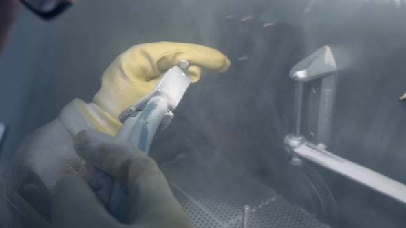 A Worker at the Factory Grinds the Parts