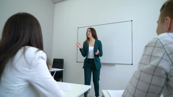 Business Coach Addressing Audience at Meeting