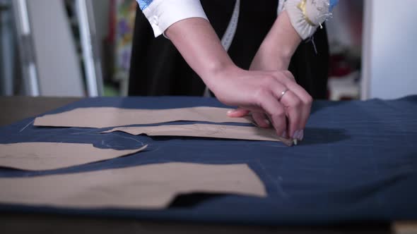 Female Hands Tracing Pattern on Cloth in Workshop