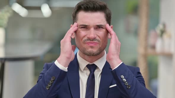 Exhausted Young Businessman Having Headache