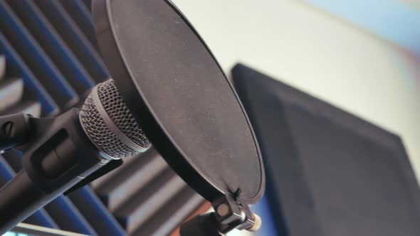 Vocal microphone for singing and recording a podcast in music bedroom studio.