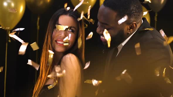 Black Man Dancing With Asian Woman at Night Club Under Falling Confetti, Relax