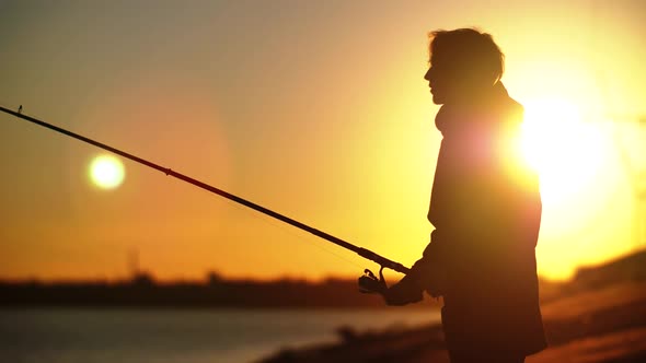 Average Fisherman's Plan with Fishing Rod Against Sunset