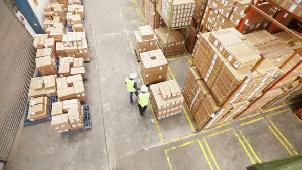 Warehouse Workers Inspect Cardboard Boxes